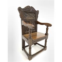 Victorian 17th century design oak Wainscot chair, the back profusely carved with leaves and scrolls, open arms, panelled seat, raised on turned supports united by stretcher W61cm