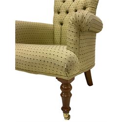 Pair Victorian design armchairs, scrolled back and arms, upholstered in buttoned spotted fabric, raised on turned front supports with brass cups and castors