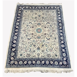 Large Persian design ivory and blue ground carpet, central medallion surrounded by interlaced trailing foliate, guarded border, 380cm x 272cm