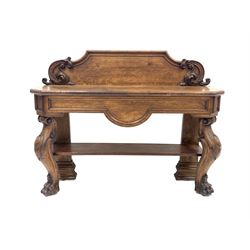 Victorian oak console table, the raised back with applied floral moulding over rectangular top with canted corners and panelled frieze with shaped apron, raised on shaped supports with paw feet W140cm, H108cm, D44cm