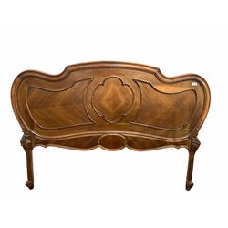 Early 20th century French walnut headboard of lobed oval design, with applied scrolled floral mounts, raised on scrolled supports, W155cm