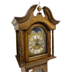 A late 20th century oak cased Grandmother clock with a swan’s neck pediment and ball and spire finial, glazed break arch hood door with four turned pillars, full length glazed trunk door with a break arch top, trunk on a square plinth raised on bracket feet, with a weight driven three train German chiming movement, chiming the quarters and striking the hours on gong rods, brass break arch dial with a working moon disc, subsidiary day, date, month and seconds dials, silvered chapter ring and steel serpentine hands. With weights, chains and pendulum.




