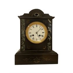 French - 8-day 19th century mantle clock in a slate and variegated marble case, with a striking movement, striking the hours and half hours on a bell. enamel dial with Roman numerals and steel moon hands, case with incised decoration and inlaid marble panels.