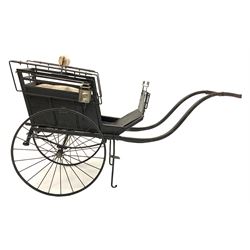 Late 19th century ebonised hand drawn child's carriage, stencilled gilt monogram 'HWB' over 'Perseverando' with two original carriage lamps, raised on leaf suspension and spoke wheels with rubber treads, the central hub inscribed 'W. Brooke Builder Manchester' having been completely restored in the 20th century L164cm