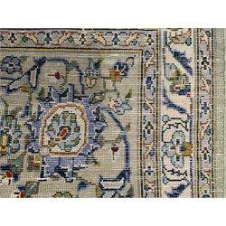Persian Kashan ivory ground carpet, overall floral design with stylised flowerheads and trailing leafy branches, repeating border with stylised peony motifs, with multiple guard bands