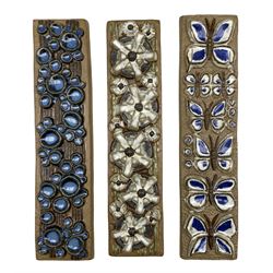 Marianne Starck for Michael Andersen & Son, Bornholm, three rectangular stoneware relief plaques, the first decorated with Butterflies no. 6317, the second with abstract flowers no. 6318 and another no. 6316, 41cm x 9.5cm max (3)