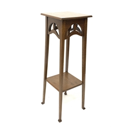 Arts and Crafts style oak jardinière stand, with pierced frieze, raised on square tapered supports united by under tier, H92cm