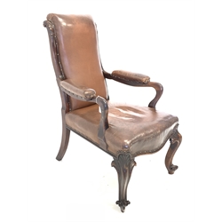 Early to mid 19th century rosewood library open armchair, traditionally upholstered in studded brown leather, with leaf carved uprights, shapely arm terminals, serpentine seat, raised on leaf carved and scrolled cabriole front supports