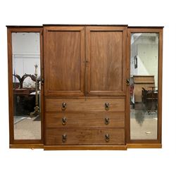George III mahogany breakfront Gentleman's press, the central panelled doors enclosing five sliding trays over three cockbeaded drawers with lion mask handles, the flanking cupboards with full length mirror panels concealing hanging rails and drawers, raised on plinth base