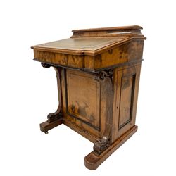 Victorian walnut davenport, removable top section with correspondence compartment over sloped top with green inset, the interior fitted with drawers, the lower section fitted with cupboards, on brass and ceramic castors 