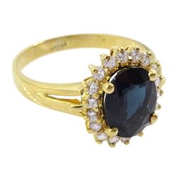 18ct gold oval cut sapphire and round brilliant cut diamond cluster ring, stamped 750
