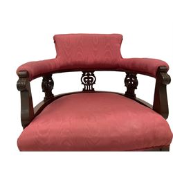 Pair late Victorian mahogany framed tub armchairs, scrolled back over pierced and carved foliate splats, sprung seat upholstered pink fabric, on cabriole supports with castors