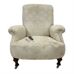 Late 19th century armchair, upholstered in white fabric with scroll arms and sprung seat, raised on turned front supports with brass castors