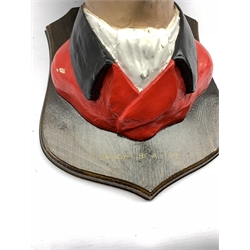 Humorous composite head figure of a Huntsman, mounted on shield inscribed 