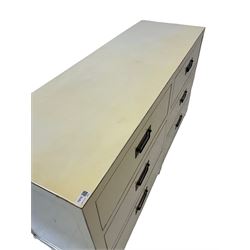 Oriental design cream finish chest, fitted with six drawers with ebonised handles, panelled sides, raised on stile supports 