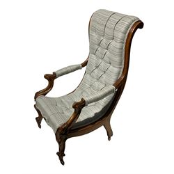 19th century carved walnut low open armchair, scrolled back and curved seat upholstered in contemporary striped buttoned fabric, the arms on carved shaped supports with foliage decoration, scroll carved cabriole front feet terminating at brass castors