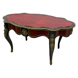 Mid-20th century French Empire design ebonised and mahogany centre table, the shaped top with egg and dart moulded cast gilt metal edge, shaped frieze rails with foliate mouldings and cartouche mounts, fitted with single drawer, on cabriole supports with ornate scroll and lion mask mounts