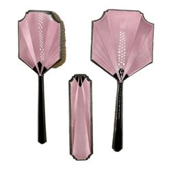 Art Deco pink and black guilloche enamel dressing table set, comprising hand mirror and two brushes, hallmarked A & J Zimmerman Ltd, Birmingham 1930 (3)