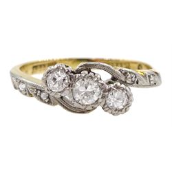 Gold three stone diamond crossover ring, with diamond set shoulders, stamped 18ct Plat, total diamond weight approx 0.30 carat