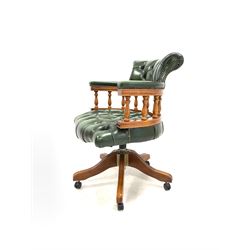 Late 20th century captains desk chair, upholstered in deep buttoned green leather, raised on a five point swivel base with castors W62cm