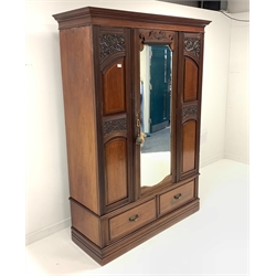 Late Victorian mahogany wardrobe, projecting cornice over panelled and carved front, centre bevelled mirror glazed door, two drawers to plinth base