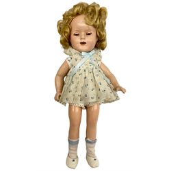 Composition Shirley Temple Reliable doll with applied hair, sleeping eyes and open mouth with teeth, composition body with jointed limbs. In original dress with undergarments, socks and shoes. Some crazing to limbs and face