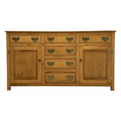 Oak dresser base, rectangular top over six drawers and two cupboards, enclosed by two panelled doors, W154cm, H84cm, D45cm