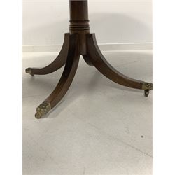 Late 20th century Regency design mahogany dining table, the oval top with one additional leaf raised on a turned column and four splayed supports terminating in brass hairy paw castors, by Gotts of Pickering 197cm x 137cm, H73cm