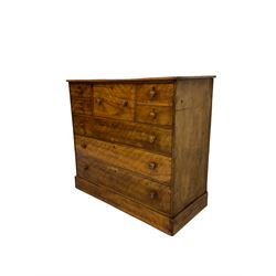 19th century distressed walnut chest, fitted with large deep centre drawer and four small drawers, above three long drawers, raised on a plinth base 
