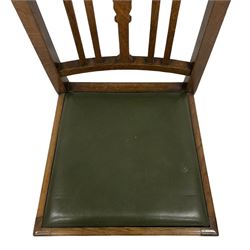 J. R. Teale & Sons (Leeds) - set of four Edwardian oak dining chairs, cresting rail with carved Yorkshire Rose over slat back, green leather drop-in seats, on spiral turned supports united by H-stretcher