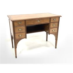 Early 20th century Arts and Crafts period mahogany writing table, the top inset with tooled leather writing surface over one long and six short drawers, raised on square tapered supports with brass feet, with reeded decoration 100cm x 51cm, H76cm