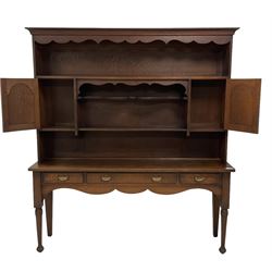 Early 20th century Georgian design oak dresser, projecting cornice with shaped apron over a three-tier plate rack with flanking fielded spice cupboards, the base fitted with three drawers, on turned supports
