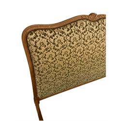 French style 4’ 6” double bedstead, carved beech framed and upholstered in raised foliate pattern fabric, decorated with flower heads