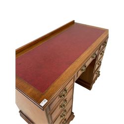 Edwardian mahogany twin pedestal desk, the raised back and inset top over one long and eight graduated drawers 