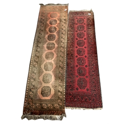 Persian design Bokhara runner rug, with gul motif on red field enclosed by multi line border, (81cm x 294cm) together with another similar rug, (70cm x 252cm)