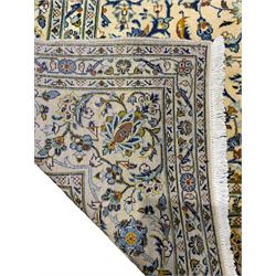 Persian ivory ground carpet, the central floral pole medallion surrounded by interlacing foliate decoration, the spandrels with scrolling flower heads, the guarded borderer decorated with repeating stylised plant motifs and trailing patterns