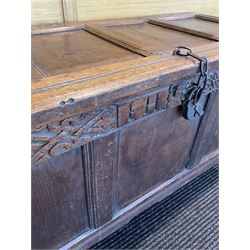 18th century oak coffer, the hinged lifting lid over carved frieze with inscription 'I H' over three panelled base, raised on stile supports 