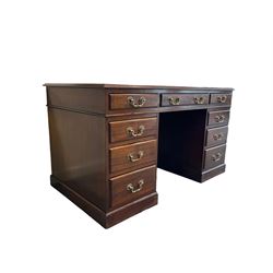 Late Victorian walnut twin pedestal writing desk, the leather inset top over one long and two short frieze drawers and six graduated drawers, raised on a plinth base 