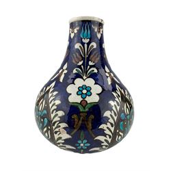 Burmantofts Faience Anglo-Persian bottle vase, designed by Leonard King, painted with stylized flowers and foliage, against a blue ground, impressed factory marks, incised 'Design 82, 483' and artists monogram LK, H25.5cm