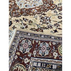 Persian design beige ground rug with floral decoration and multi line border (165cm x 136cm) together with another Persian style rug 