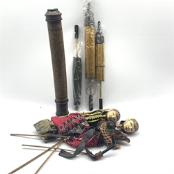 Two Indonesian rod puppets, black lacquer cylindrical scroll holder containing Burmese paintings on card and three Oriental parasols   
