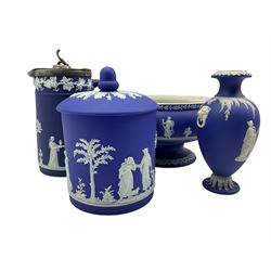 Group of late 19th/20th century Wedgwood dark blue jasper dip items comprising pedestal fruit bowl D20cm, biscuit barrel and cover, hot water jug with metal cover and a baluster vase H18cm (4)