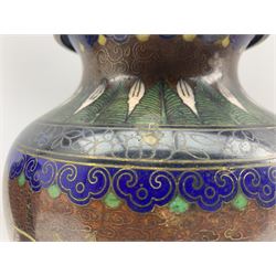 Pair of 20th century Chinese Cloisonne table lamps of baluster form, each decorated with a pair of Dragons chasing the flaming pearl amidst clouds, enclosed by floral and scroll borders, on hardwood bases with shades, H29cm