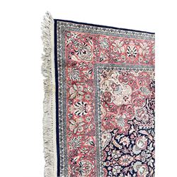 Persian design Meshed rug, cotton with silk inlay, the field with central floral medallion surrounded by scrolling and interlaced foliate branches, the guarded border decorated with repeating stylised plant motifs and trailing floral design 
