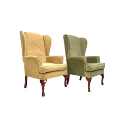 Pair of Queen Anne style wing back armchairs with squab cushion, upholstered in different fabrics, raised on cabriole supports