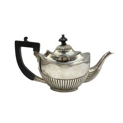 Edwardian silver bachelors teapot of oval form with half body decoration, ebonised handle and lift Birmingham 1906 Maker Henry Matthews 