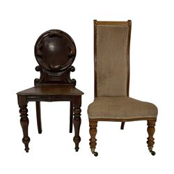 19th century walnut framed nursing chair, upholstered in hounds-tooth patterned fabric, raised on turned supports with castors (W48cm H96cm); Victorian Gillows design mahogany hall chair, circular panelled back, raised on turned supports (W45cm H88cm)