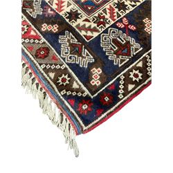 Turkish Dosemealti ivory blue and red ground rug, central elongated lozenge filled with geometric motifs, the guard bands with repeating alternating star motifs an geometric foliate patterns