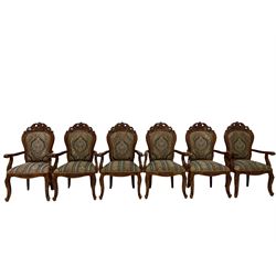 Set twelve French style cherry wood dining elbow chairs, pierced pediments decorated with flower heads and c-scrolls, upholstered in floral pattern fabric, cabriole supports carved with flower heads