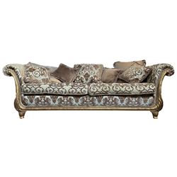 Gascoigne - 'Victoria' three seat sofa, carved and gilt finished wood frame with scrolled arms, the lower upright with carved foliate decoration, upholstered in gryphon and crown patterned fabric